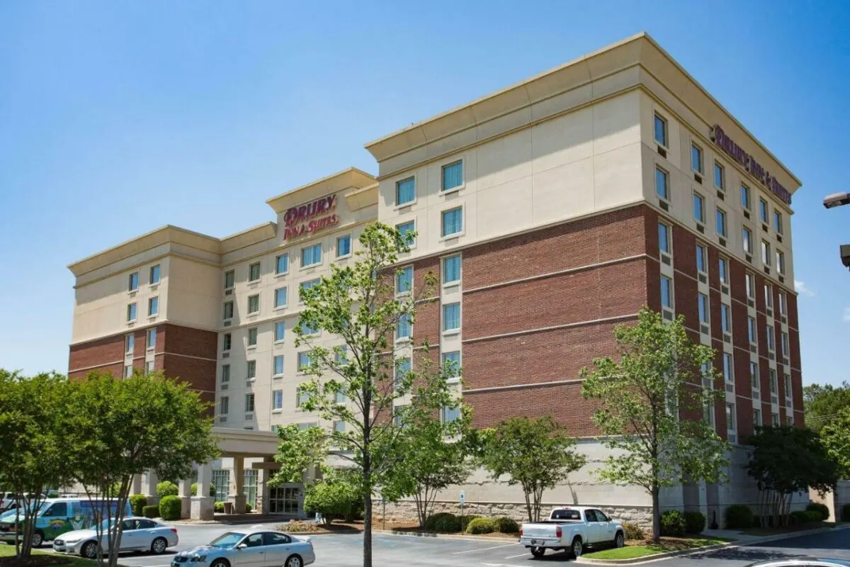 Drury inn & suites building with parking lot and cars